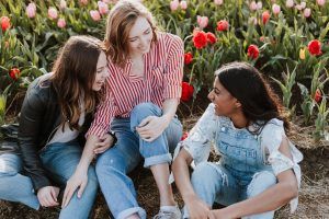 three ladies sitting in a field of flowers having a conversation, the importance of nonverbal communication blog, counseling center at cinco ranch, therapy, katy texas