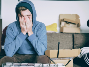 teen in hoodie with face covered