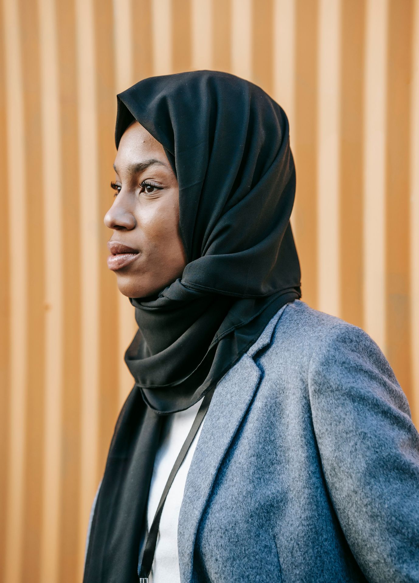 A woman wearing a headscarf in a softly lit setting