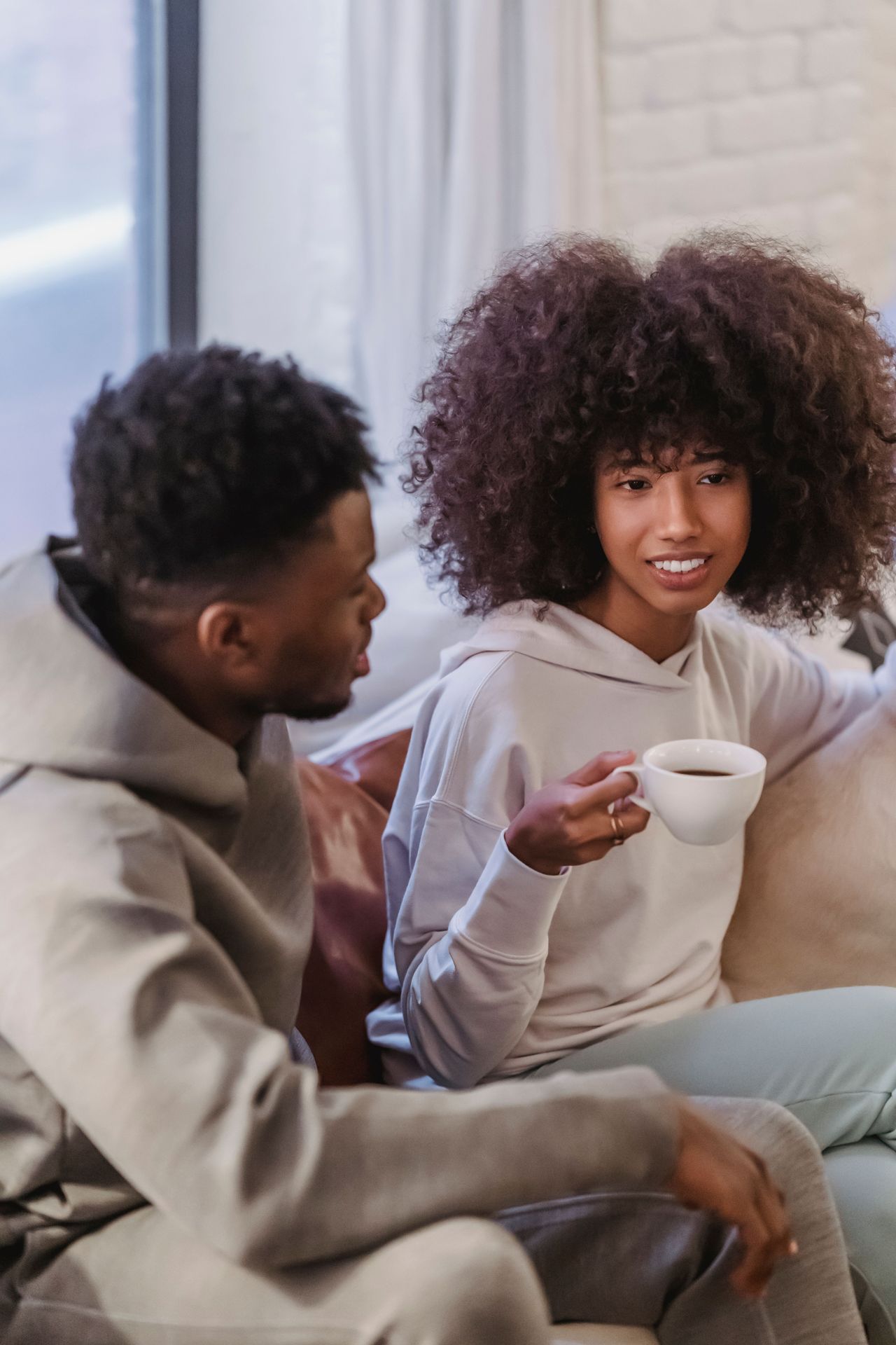 A couple sharing a conversation on a sofa