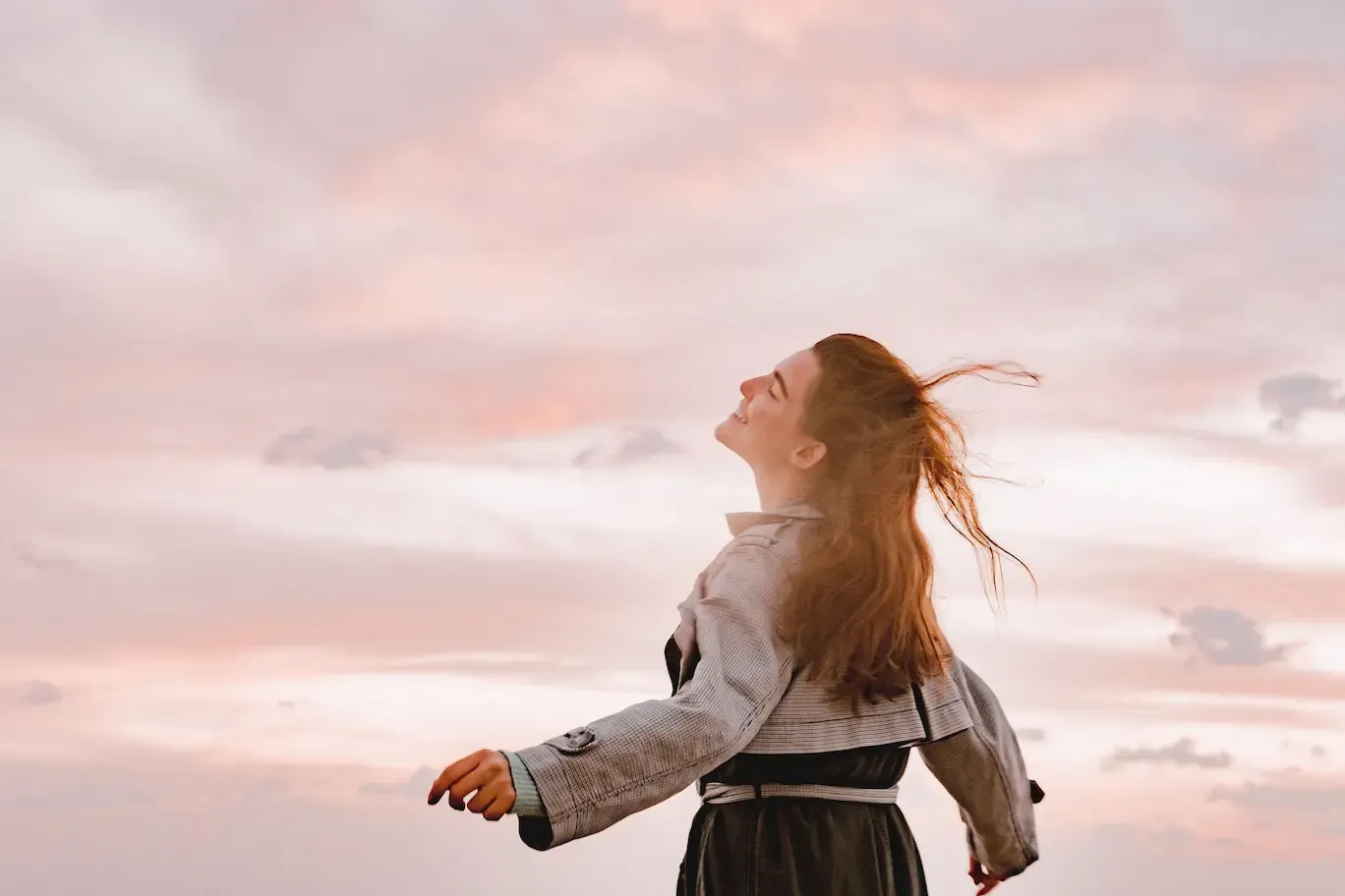 A joyful woman with arms outstretched.