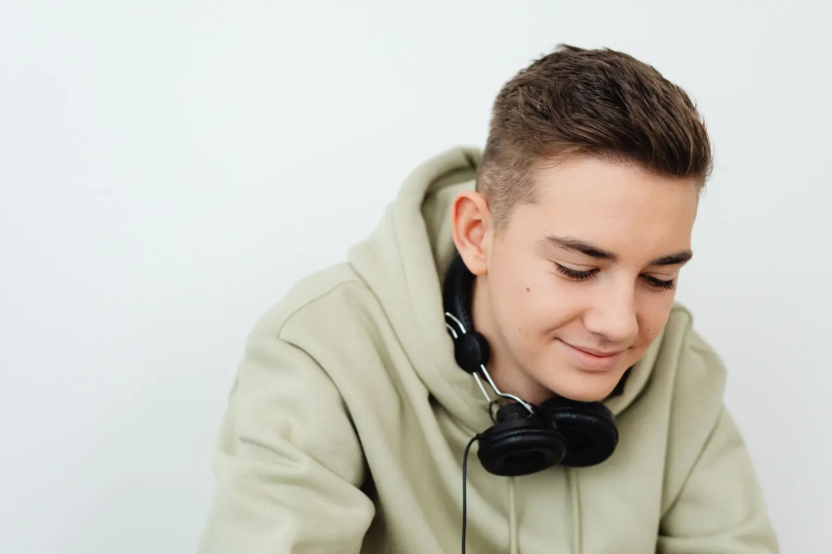 A smiling teen with headphones.