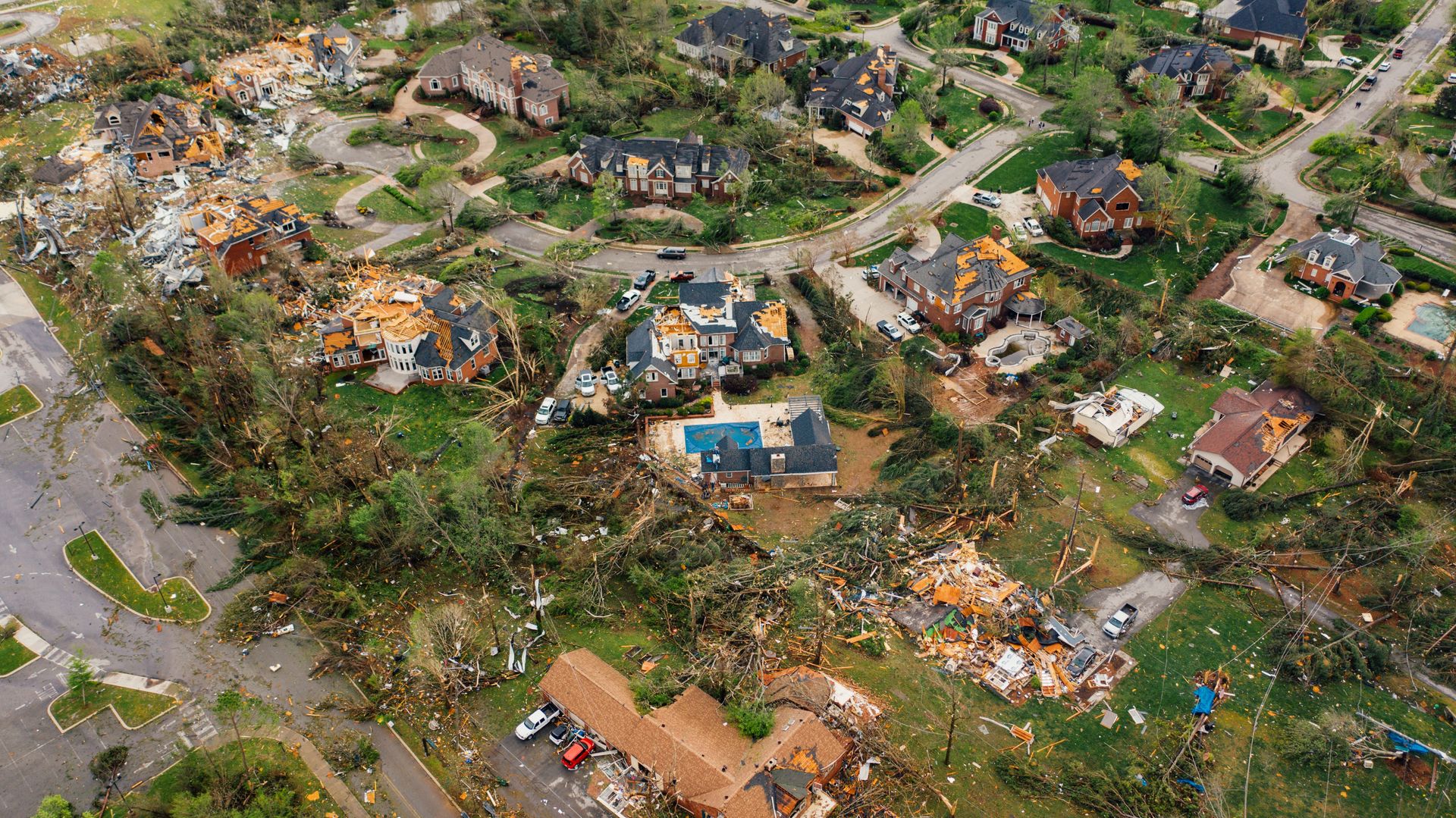 An aerial view shows a neighborhood torn apart by a storm, homes flattened and debris scattered across the yards. Disasters like this can leave lasting emotional wounds, which is why trauma treatment in Palm Beach County, FL matters. Trauma therapy in Delray Beach and a trauma therapist in Delray Beach, FL help survivors process what they've lived through.