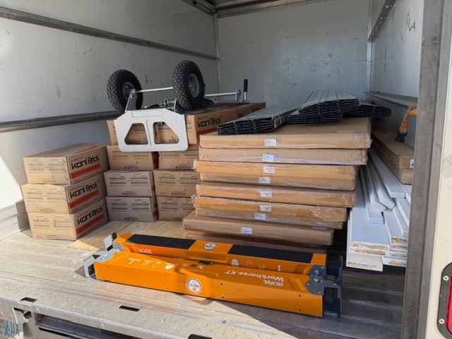A smiling woman stands in the empty new office space, cheerfully holding a level tool in one hand while pulling a rolling toolbox behind her — ready to get to work on the build-out. This candid moment captures the hands-on spirit that the Mangrove Therapy Group team brought to transforming their new home for Delray Beach therapy. Even the therapists rolled up their sleeves to help create a space worthy of the healing work done inside it as a trusted therapist in Delray Beach, FL.
