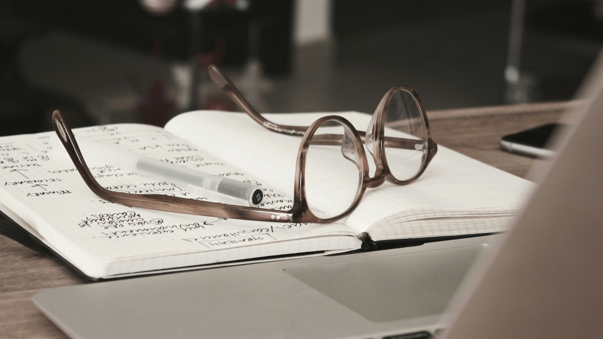Eyeglasses resting on an open notebook with handwritten notes beside a laptop, representing session planning for emdr therapy in palm beach county, fl. Find support with an emdr therapist in palm beach county, fl for trauma treatment in palm beach county, fl.