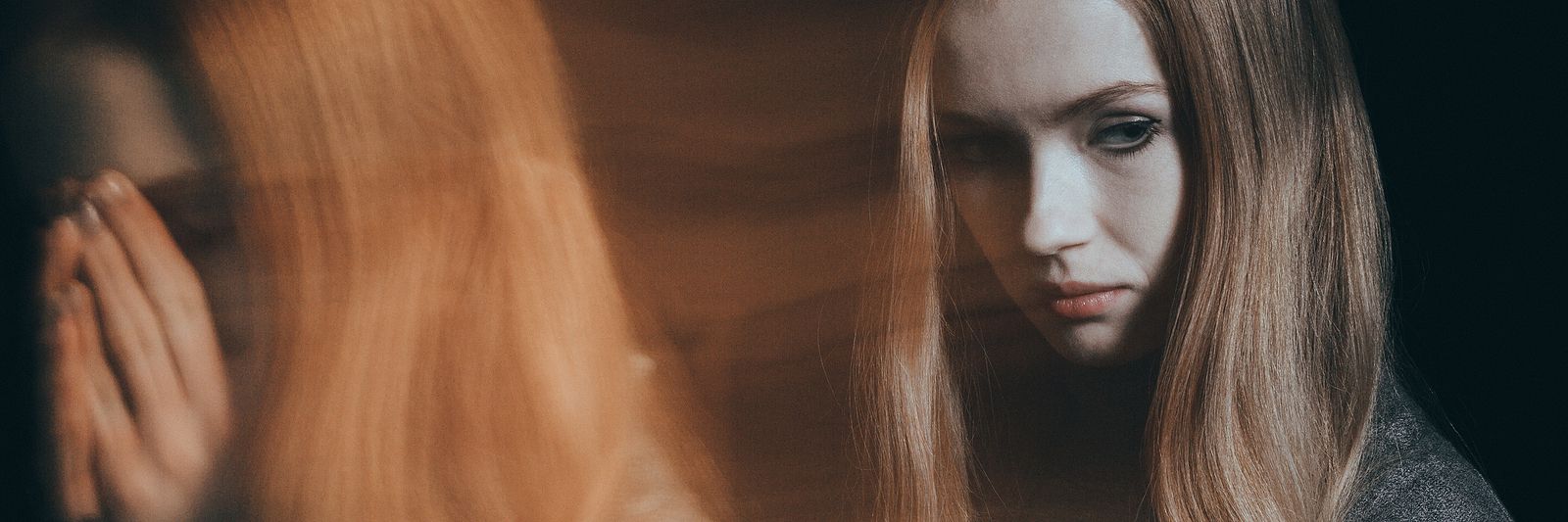 A woman reflecting on past trauma, representing the healing work with an EMDR therapist in Palm Beach County, FL, and the benefits of EMDR intensives in Palm Beach County, FL.