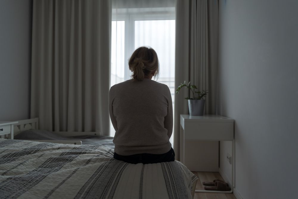 A woman sits alone on a bed, reflecting on emotional pain after narcissistic abuse. Trauma treatment in Palm Beach, FL and therapy in Delray Beach can help her regain peace and confidence.