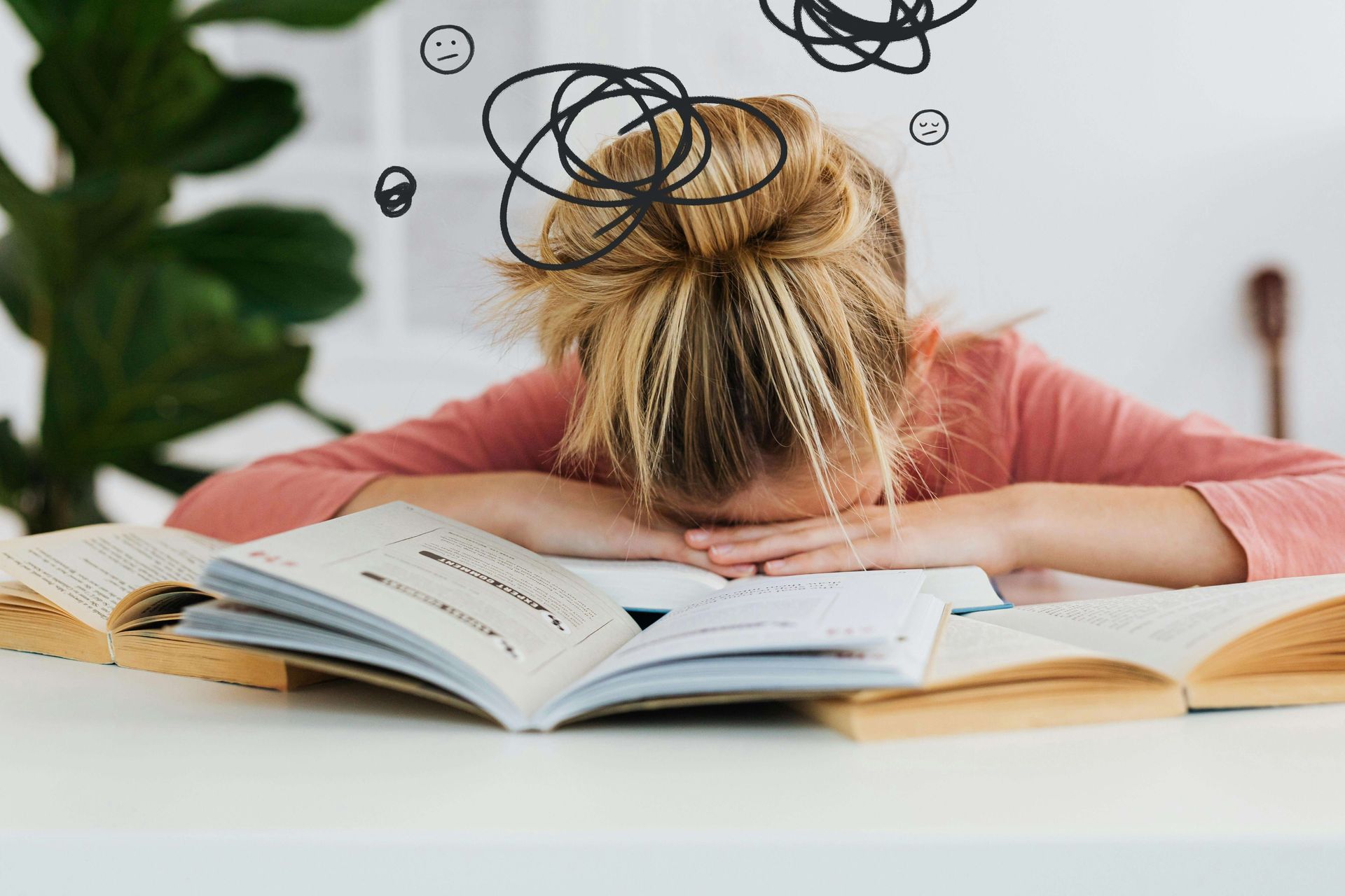 A young girl with blonde hair tied in a messy bun is resting her head on an open book, surrounded by other open books. She appears exhausted or overwhelmed. Above her head are digitally added doodles of scribbles and sad faces. This could represent issues with procrastination that an EMDR therapist in Palm Beach County, FL can help address. Learn more about EMDR therapy in Palm Beach, FL by searching for an EMDR therapist in Miami, FL today. 33431 | 33432 | 33486