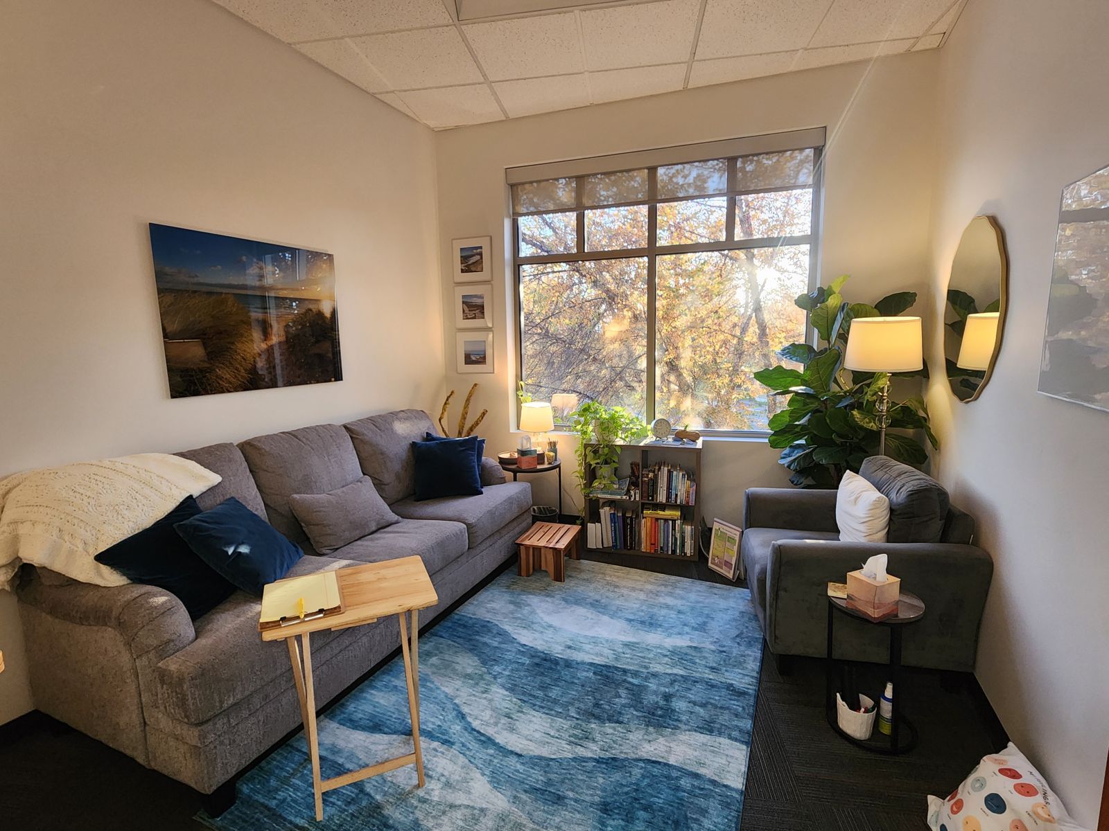 Hurlbert Counseling office in Eagle, Idaho, with a cozy couch, armchair, plants and sunny window