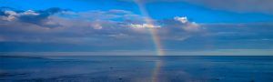 Rainbow over the water representing how a health psychologist can help you find meaning and purpose through counseling with a psychologist.