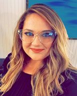 A headshot of Justine as she smiles for the camera. She is a couples therapist in Saint Petersburg, FL. Contact a marriage counselor in Tampa, FL for support with couples therapy and other services!