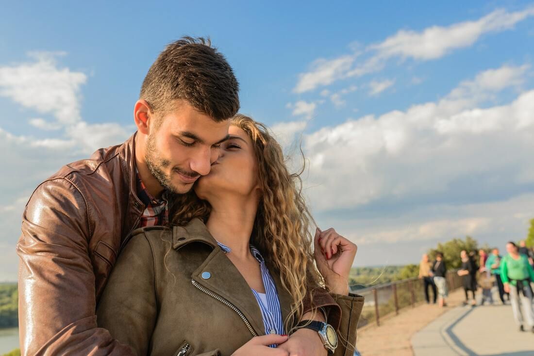 A loving couple embrace as they kiss on a sidewalk. Contact a couples therapist in Saint Petersburg, FL for support with marriage counseling in Tampa, FL and more! 33609 | 33703