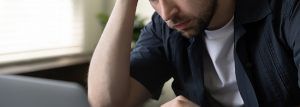 A close up of a man with a concerned experssion on his face. Learn how a DBT therapist in St. Pete, FL can offer support by searching "dbt therapy in st. pete, fl" today for support.