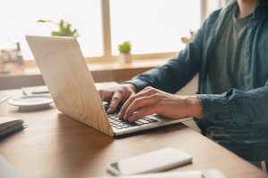 A close-up of a woman typing on a laptop on a desk. This could represent searching for psychological testing near me to start psychological testing in Tampa, FL. Our team of skilled therapists offers Florida counseling and evaluation services across the state.