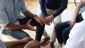 A close-up of a person gesturing with their hands while sitting in a circle with other people. Learn how group therapy in St. Petersburg, FL can offer support by contacting a group therapist in St. Petersburg, FL today. They can offer group therapy for men in St. Petersburg, FL and other services. 