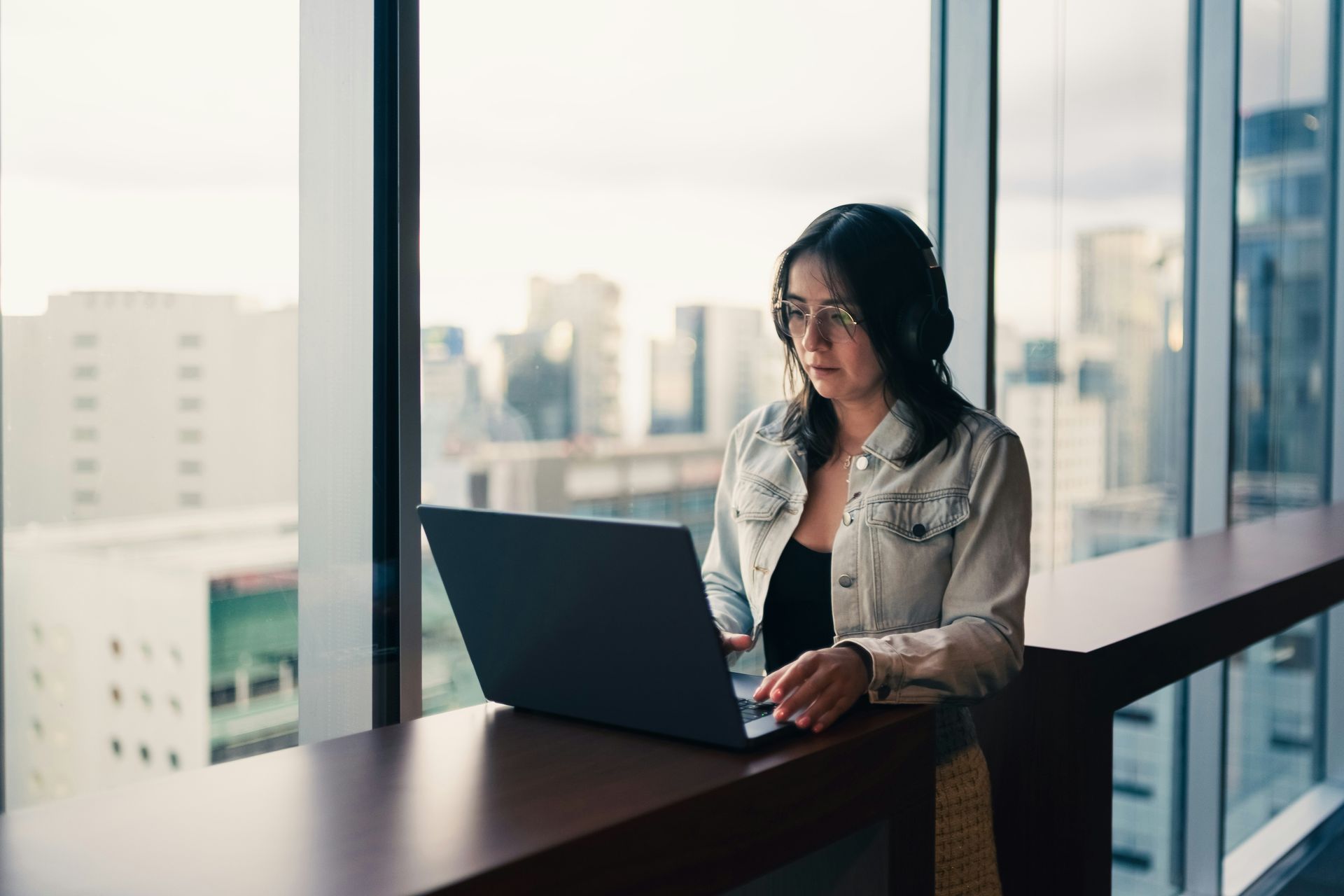 Woman sitting with lap top at work