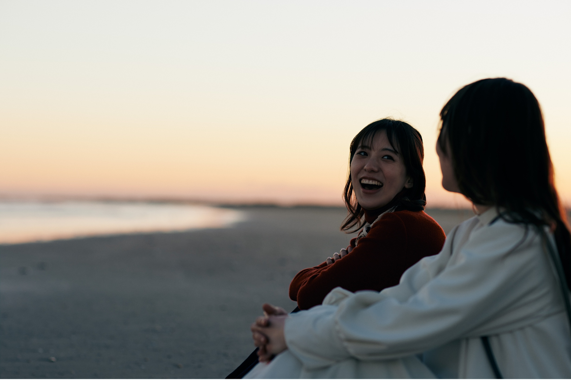 two women talking on the beach
