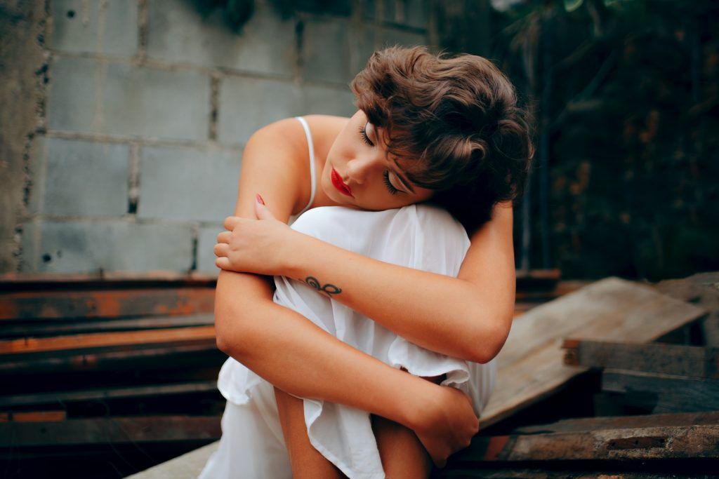A woman sits in a fetal position with a tired expression. Learn how anxiety treatment in Atlanta, GA can offer support in addressing anxiety from the comfort of home. An anxiety therapist in Atlanta, GA can offer online anxiety treatment in Atlanta, GA and other services today.