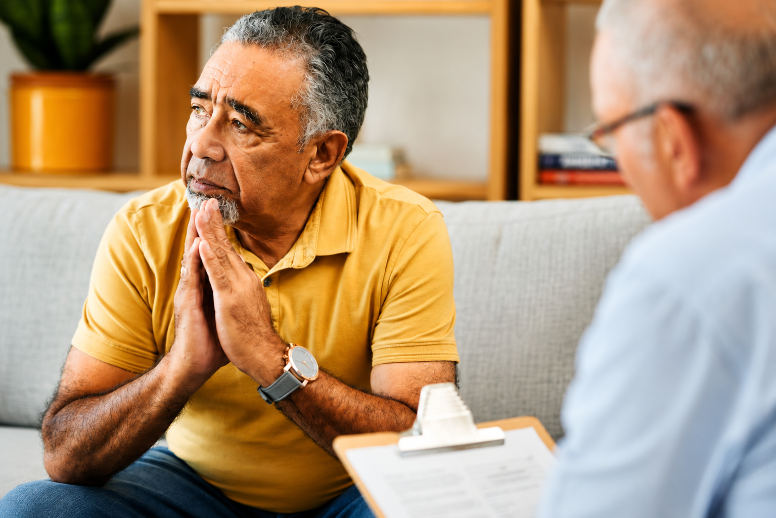 Older adult sitting comfortably and talking with a therapist about anxiety.