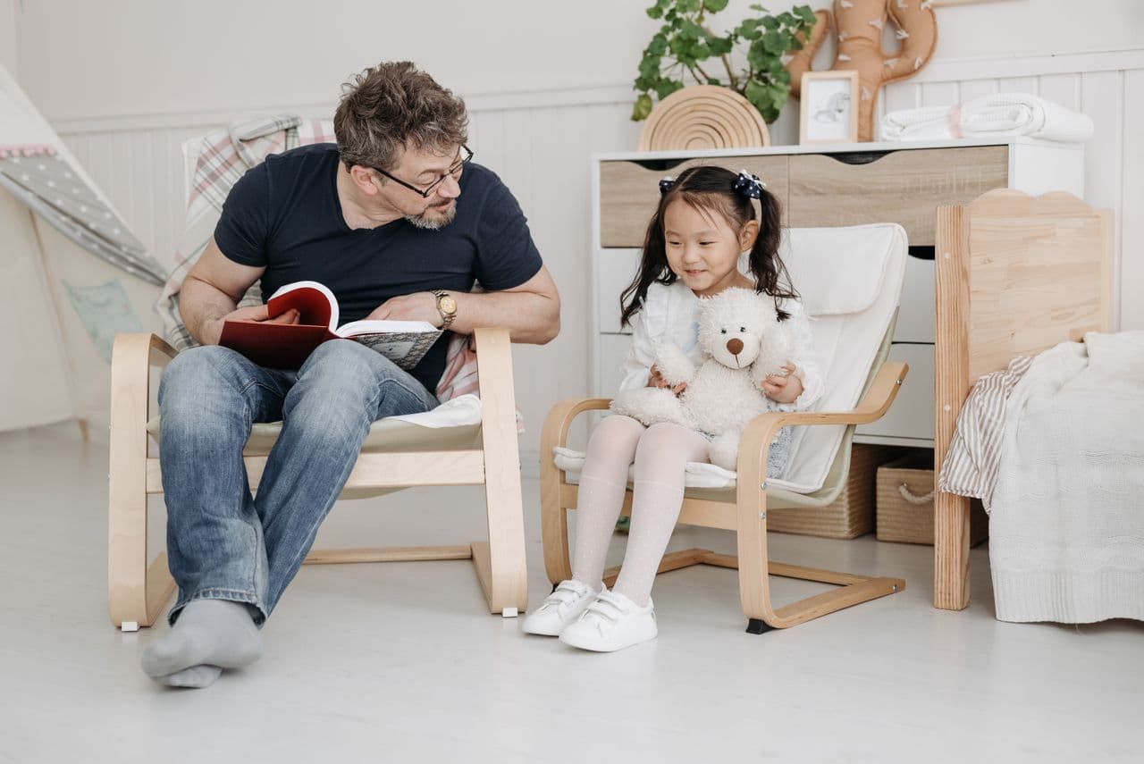 father-reading-a-book-to-his-daughter